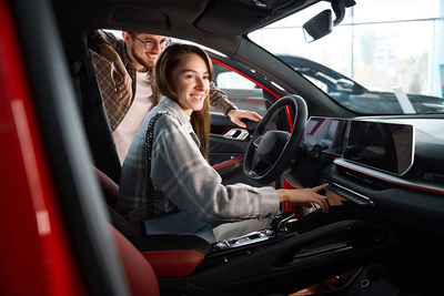 Woman sat in red car