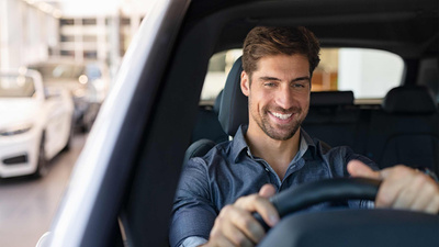 man smiling in a car