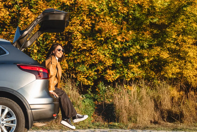 Female sat in car boot