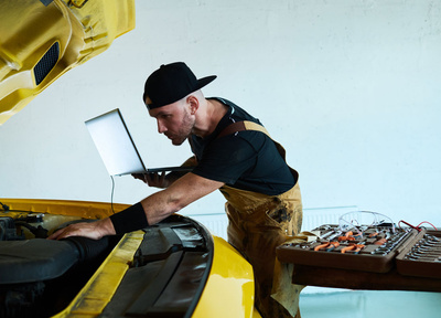 Technician carrying out maintenance on an electric car
