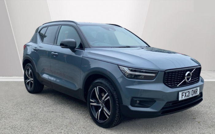 Blue Volvo XC40 compact SUV parked on a grey paved surface with a plain light-grey and white background. The vehicle has a UK registration plate FX21 ONR. The car features modern LED headlights, black grille with the Volvo emblem, black side mirrors, and alloy wheels. This image is suitable for advertising used cars and new cars, highlighting a clean and well-maintained Volvo model.