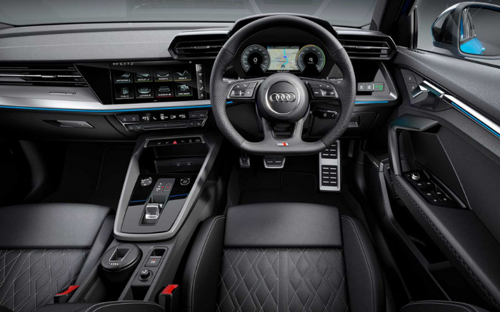 Interior view of a modern Audi car featuring a digital dashboard with navigation display behind the steering wheel, multi-function controls on the leather-wrapped steering wheel, quilted leather seats, and a central touchscreen showing drive select options. The sleek black dashboard and centre console include climate control settings and various drive mode buttons, illustrating a high-tech driver environment ideal for used cars and new cars buyers seeking premium features.