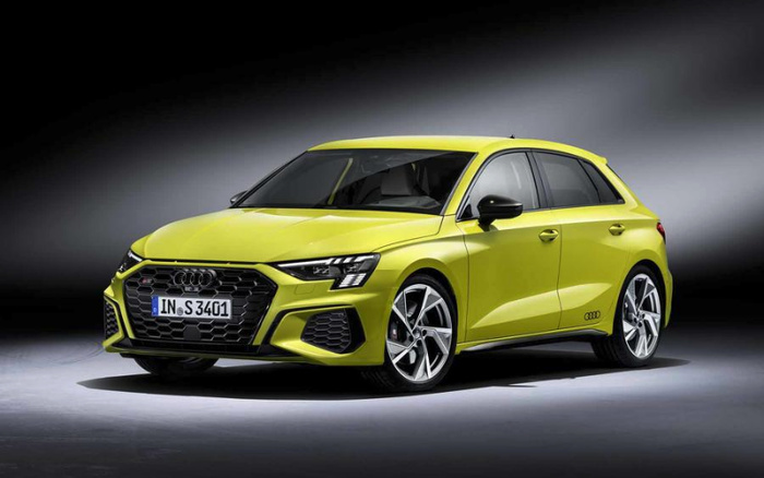 Bright yellow Audi S3 hatchback car with sporty design, honeycomb grille, and distinctive LED headlights displayed in a studio setting, ideal for showcasing used cars and new cars.