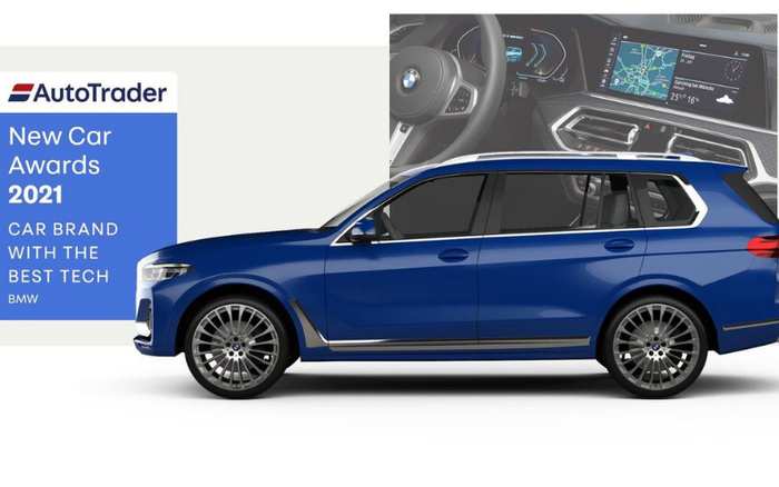 AutoTrader New Car Awards 2021 banner highlighting BMW as the car brand with the best tech. Side view of a blue BMW SUV with inset image showing the digital dashboard and infotainment screen displaying navigation and vehicle information. The image emphasises BMW's advanced technology features in new cars, relevant for both used cars and new cars buyers.