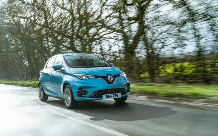 Blue Renault electric car with licence plate REN 135 driving on a tree-lined road, representing both used cars and new cars options.