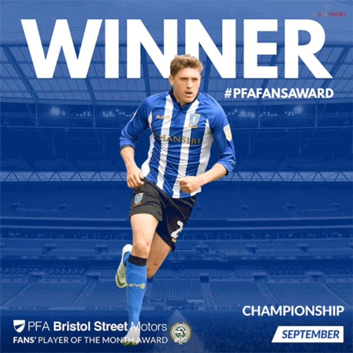 Football player in blue and white striped Sheffield Wednesday kit running on pitch with bold text 'WINNER #PFAFANSAWARD' above. Below, text reads 'PFA Bristol Street Motors Fans' Player of the Month Award, Championship September'. Background features stadium seating. Keywords used cars and new cars subtly referenced through Bristol Street Motors sponsorship.