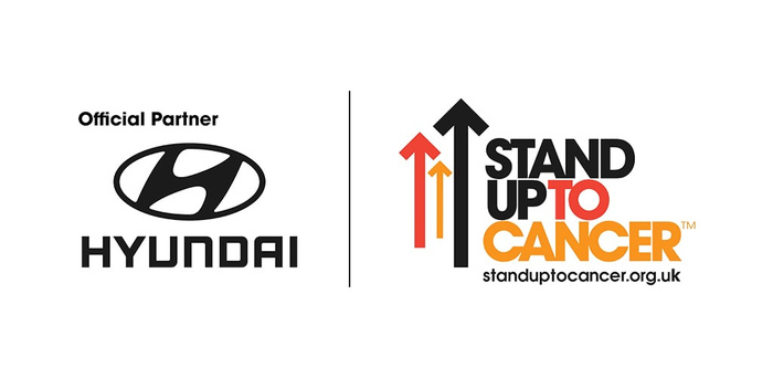 Official Partner Hyundai logo displayed alongside the Stand Up To Cancer logo with three upward arrows in red, orange, and black, and the text standuptocancer.org.uk, highlighting Hyundai's partnership with the cancer charity, relevant for used cars and new cars promotions.
