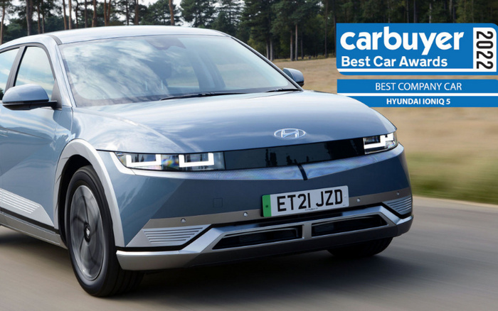 Blue Hyundai Ioniq 5 driving on a road with a forest background, featuring a UK registration plate ET21 JZD. Overlay text reads 'carbuyer Best Car Awards 2022, Best Company Car, Hyundai Ioniq 5'. Image highlighting recognition relevant to both used cars and new cars.