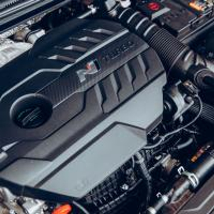 Close-up view of a high-performance car engine with branding showing 'TDI' and 'M Performance', highlighting detailed engine components in a well-maintained vehicle, suitable for showcasing the quality of used cars and new cars.