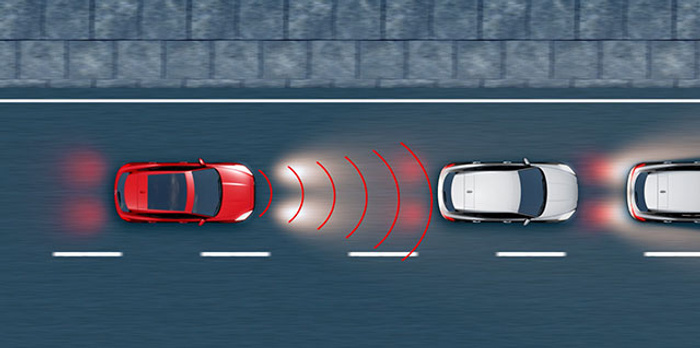 Overhead view of a red car on a road using forward collision warning technology, detecting a white car ahead with red waves indicating sensor signals, illustrating advanced safety features in used cars and new cars.