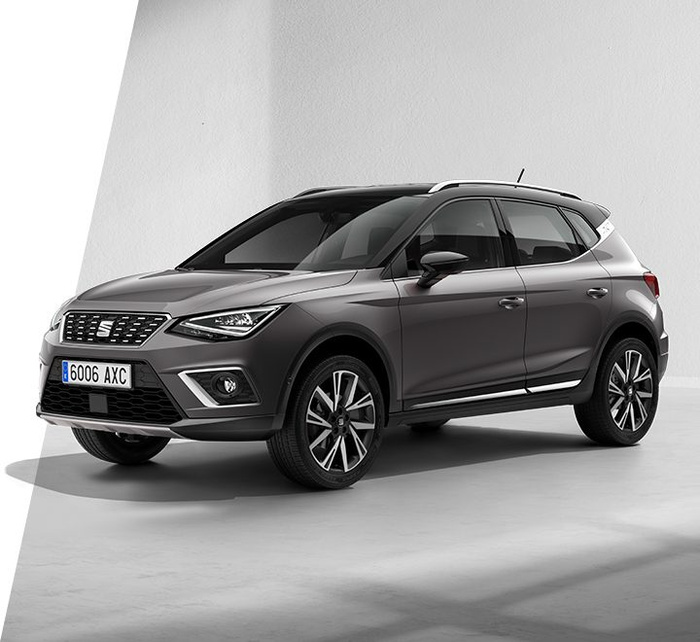Grey SEAT SUV car with Spanish license plate 6006 AXC parked in a white studio setting, showcasing modern design and alloy wheels, suitable for advertising used cars and new cars.