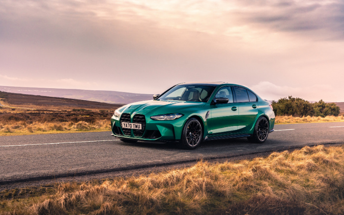 Green BMW M3 sports car with registration YA70 TWU parked on a countryside road under a cloudy sky at sunset, showcasing sleek design and black alloy wheels, ideal for buyers interested in high-performance used cars and new cars.