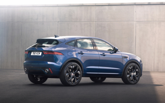 Blue Jaguar E-PACE compact SUV parked outdoors near a concrete wall, rear and side view showing sleek design and black alloy wheels, registration plate reading '760 VCM', suitable for used cars and new cars market.