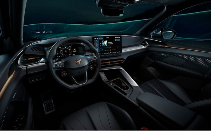 Interior view of a modern car showcasing the steering wheel with the Cupra logo, digital instrument cluster displaying speed and other information, and a central touchscreen featuring a music player interface with 'Black Magic' by Swarup Sinha. The dashboard has sleek design elements with ambient lighting, leather seats, and detailed door panel with speaker and control buttons. This high-tech car interior is ideal for advertising used cars and new cars.