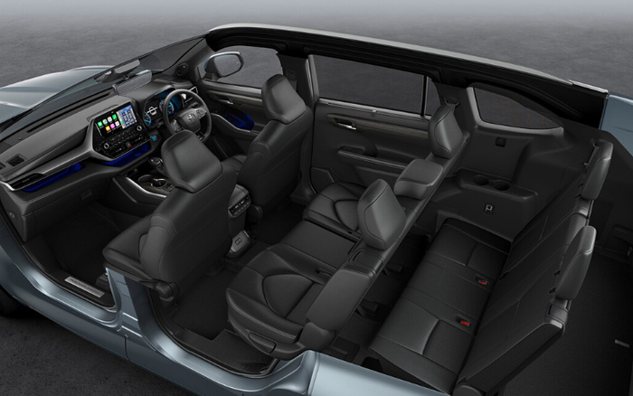 Interior view of a modern car showing three rows of black leather seats, a digital infotainment screen on the dashboard displaying navigation and media controls, and the driver's steering wheel with mounted controls. The image highlights spacious seating and modern features suitable for both used cars and new cars.