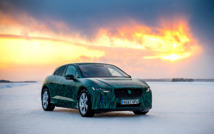 Jaguar electric car prototype with UK license plate VE67 OFU parked on a snowy landscape during sunset, showcasing advanced design. Ideal for buyers interested in used cars or new cars with innovative technology.