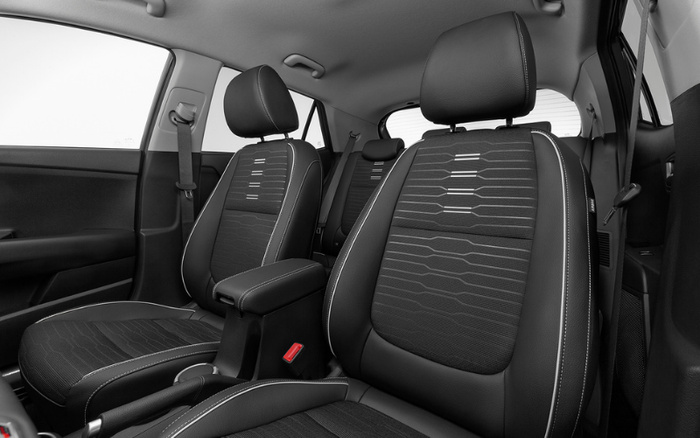 Interior view of a modern car showing the front seats and part of the rear seats with black fabric upholstery and light stitching detail, highlighting the clean and spacious design suitable for both used cars and new cars buyers.