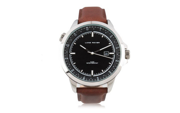 Close-up of a Land Rover branded wristwatch with a black dial, silver markers, and a date display showing the 28th, featuring a brown leather strap. The watch face includes text 'LAND ROVER', '10 ATM', and 'WATER RESISTANT'. The image relates to the Land Rover brand, known for used cars and new cars.