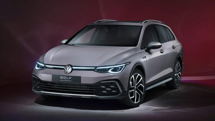 Front view of a silver Volkswagen Golf Alltrack with LED headlights illuminated against a dark red background, showcasing a sleek modern design. The image is suitable for advertising used cars and new cars.