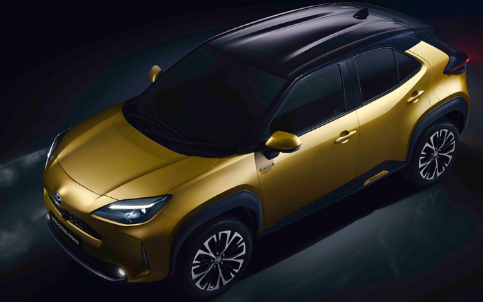 Gold and black Toyota Yaris Cross Hybrid compact SUV shown from an elevated front-side view, highlighting sleek design and modern alloy wheels, representing options for used cars and new cars.