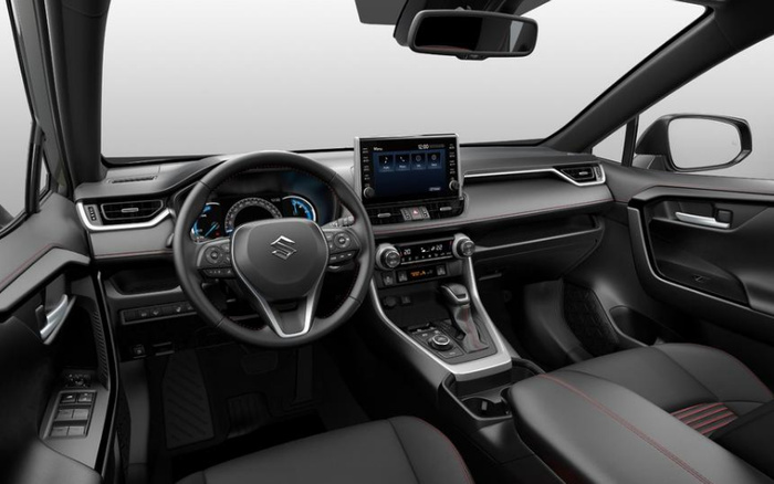 Interior view of a Suzuki car showcasing the driver's seat, steering wheel with Suzuki logo, dashboard with illuminated speedometer, touchscreen infotainment system displaying 12:00 with menu options, dual-zone climate control set to 20°C, gear shift, and modern black upholstery with red stitching, ideal for used cars and new cars buyers.