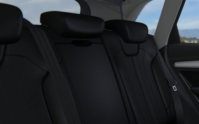 Interior view of the back seat of a car with black leather upholstery, showing two headrests and seatbelts, highlighting the sleek and modern design typical of new cars and used cars for sale.