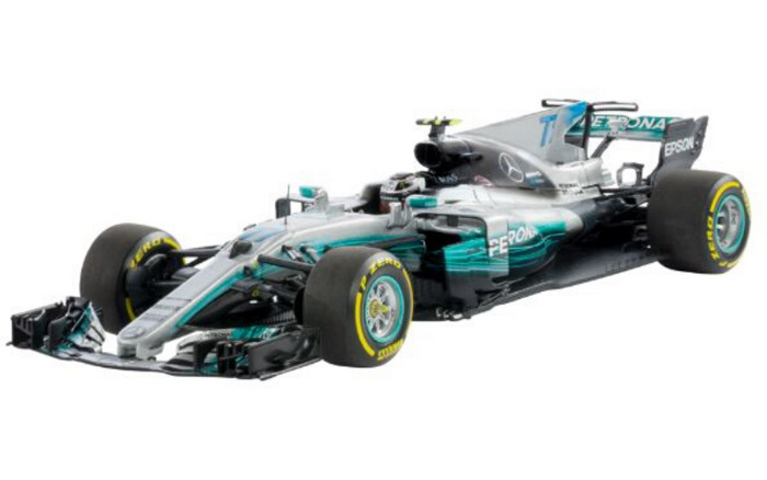 Silver and turquoise Mercedes Formula 1 racing car with Pirelli tyres and visible sponsor logos including Petronas and Epson, isolated on white background, representing high-performance new cars in the automotive industry alongside used cars.