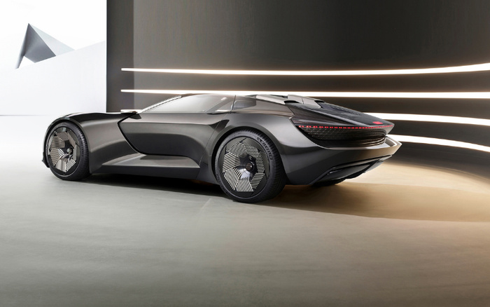 Sleek black futuristic concept sports car displayed indoors with modern geometric decor and horizontal light strips in the background, representing new cars and innovation in automotive design, ideal for showcasing new cars alongside used cars options.