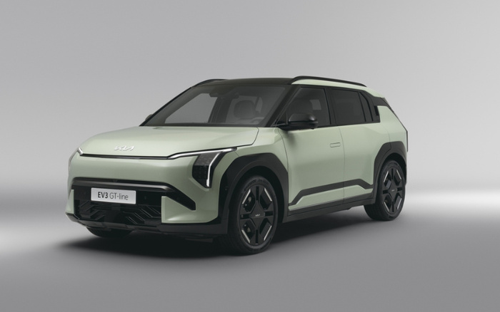 Light green Kia EV3 GT-line electric vehicle displayed on a plain grey background, showcasing a sleek and modern design prioritising new cars in the automotive market.