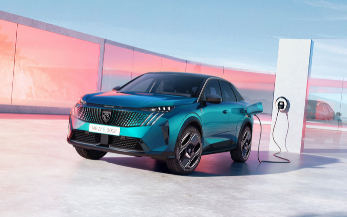 New PEUGEOT e-3008 plugged into a charging point