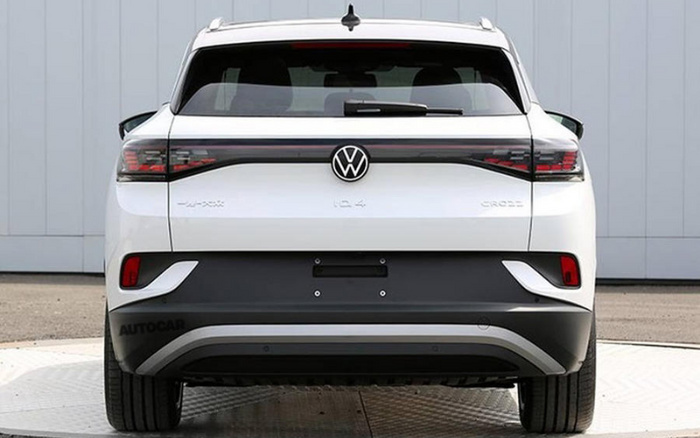 Rear view of a white Volkswagen ID.4 CROZZ electric vehicle parked on a light concrete surface with a grey and white background, showcasing the VW logo, model name ID.4, and CROZZ badge, representing used cars and new cars options.