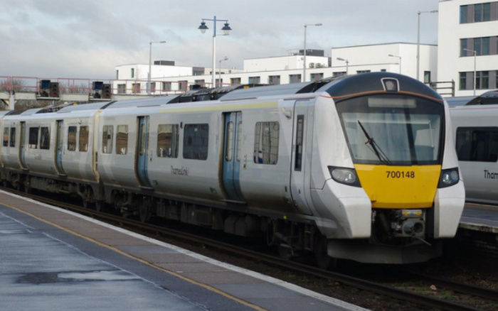 Modern passenger train numbered 700148 at a train station platform with the name Transport for Wales on the side, no used cars or new cars visible in the image