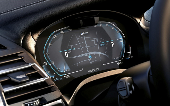 Close-up of a modern car dashboard digital display showing a speedometer with a reading of 0 km/h, a navigation map with a route on Hauptstrasse, the time 15:00, outside temperature +21.5°C, and eDrive status indicating ECO PRO mode and ePower at 1%. The image highlights features typical of new cars dashboard technology, relevant for used cars buyers considering advanced digital displays.