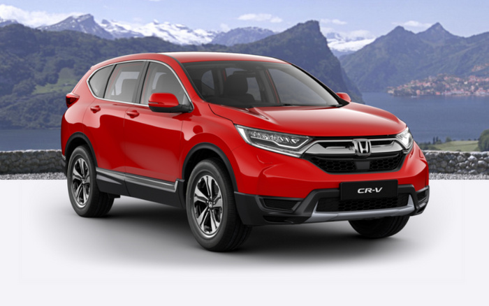 Red Honda CR-V SUV car displayed against a scenic mountainous and lake backdrop, showcasing the front and side view, representing new cars and used cars options.