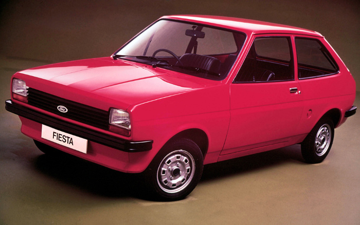 Red Ford Fiesta classic hatchback car in studio setting with white license plate reading 'FIESTA', suitable for promotion of used cars and new cars.