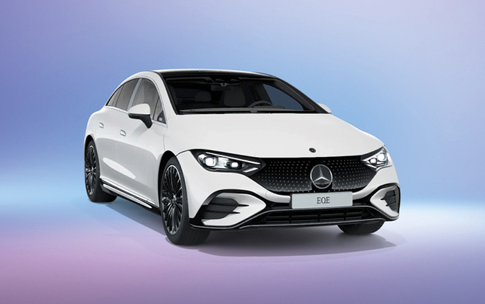 White Mercedes-Benz EQE electric car shown from the front-side angle against a gradient background from purple to blue, featuring sleek design with black grille, LED headlights, and model name EQE on the front licence plate, ideal for new cars or used cars advertisements.