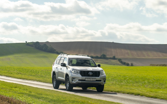 Toyota Land Cruiser driving along country road