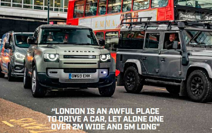 Two Land Rover Defender vehicles on a busy London street with a red double-decker bus in the background. The image includes the text: 'London is an awful place to drive a car, let alone one over 2m wide and 5m long.' The photo highlights the challenge of driving large new cars and used cars in London traffic.