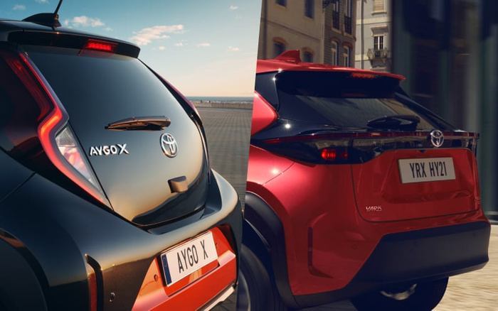 Split image showing rear views of two Toyota cars: a black Toyota Aygo X with registration plate AYGO X parked by a seaside promenade under a clear sky, and a red Toyota Yaris with registration plate YRX HY21 driving in an urban setting. The image highlights both used cars and new cars models by Toyota.