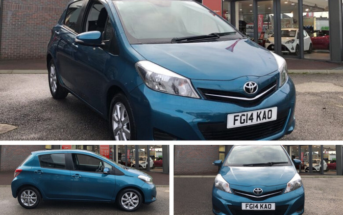 Blue Toyota Yaris car with registration plate FG14 KAO parked outside a dealership showing front, side, and angled views. The dealership showcases used cars and new cars inside the showroom through glass windows in the background.
