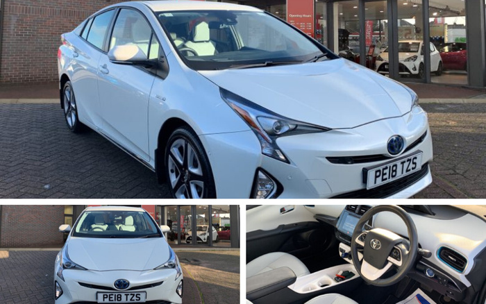 White 2018 Toyota Prius with registration plate PE18 TZS parked outside a car dealership. The dealership has large glass windows and a door with a red sign showing opening hours. Interior view of the car shows a clean dashboard with a touchscreen infotainment system and a black and cream steering wheel with Toyota logo. The images highlight both used cars and new cars available at the dealership.