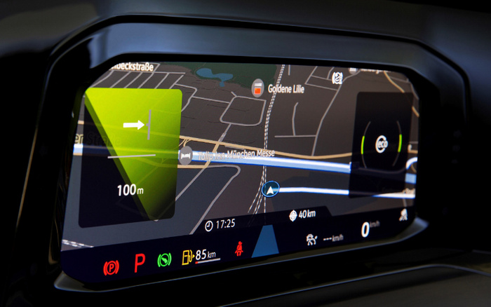 Car dashboard digital display showing a navigation map with directions to make a right turn in 100 metres near Tulip Inn München Messe and Goldene Lilie. The screen indicates the vehicle is in park mode with 85 km fuel range remaining, eco mode active, time at 17:25, and current speed at 0 km/h, highlighting features relevant to used cars and new cars with modern navigation and driver assistance technology.