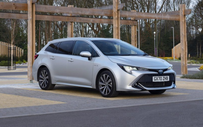 Silver Toyota Corolla hatchback car with license plate GX70 ZHB parked outdoors near wooden pergola and trees, showcasing a modern sleek design ideal for buyers interested in new cars or used cars.