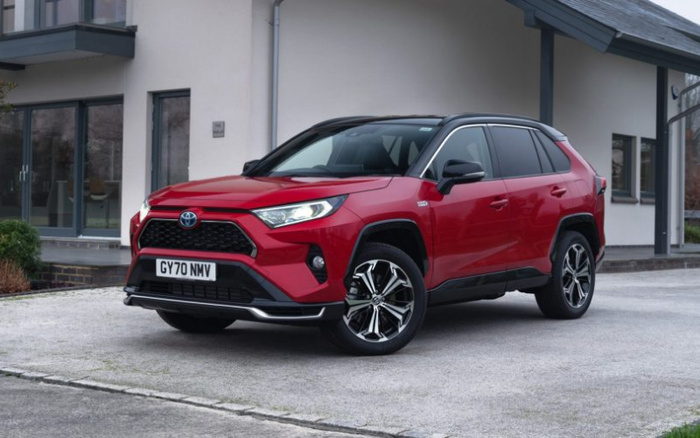 Red Toyota SUV parked in front of a modern house with grey roof and white walls, vehicle registration plate reads GY70 NMV, showcasing a new car model, ideal for used cars and new cars buyers.