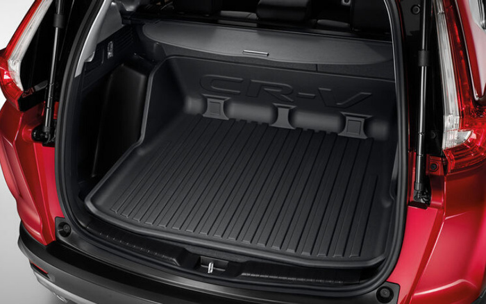 Open boot of a red Honda CR-V showing a clean, black protective cargo liner embossed with the CR-V logo. The image highlights the spacious and well-maintained trunk area, suitable for carrying luggage or groceries, ideal for customers looking for used cars or new cars with practical storage solutions.