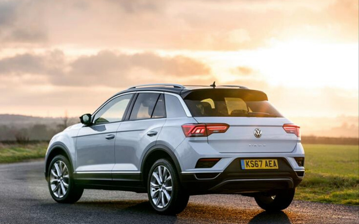 Silver Volkswagen T-Roc SUV parked on a country road at sunset with license plate KS67 AEA, showcasing a new car model ideal for buyers interested in used cars and new cars.