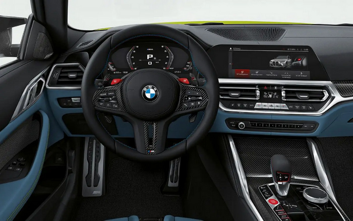 Interior view of a BMW car dashboard featuring a black leather steering wheel with BMW logo, digital instrument cluster displaying gear position 'P', and advanced infotainment screen showing car setup options. The dashboard includes climate control buttons, carbon fibre trim around the gear shift, and modern control buttons. This sleek interior design highlights features commonly found in both used cars and new cars.